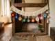 Cream crochet toran with nine colourful crochet flowers hanging near a Navratri puja corner